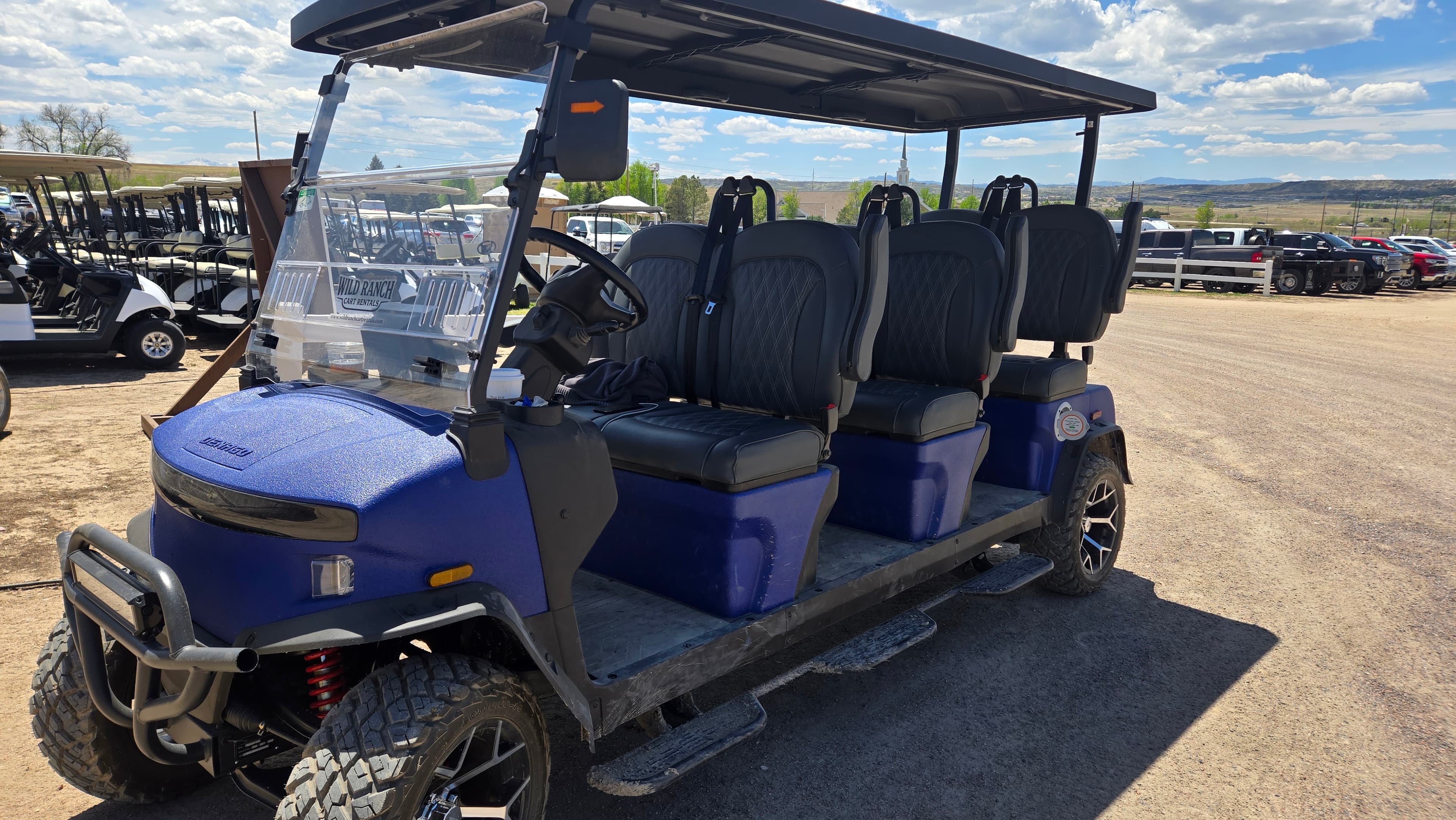 A branded Wild Ranch blue 6-seater lifted golf cart